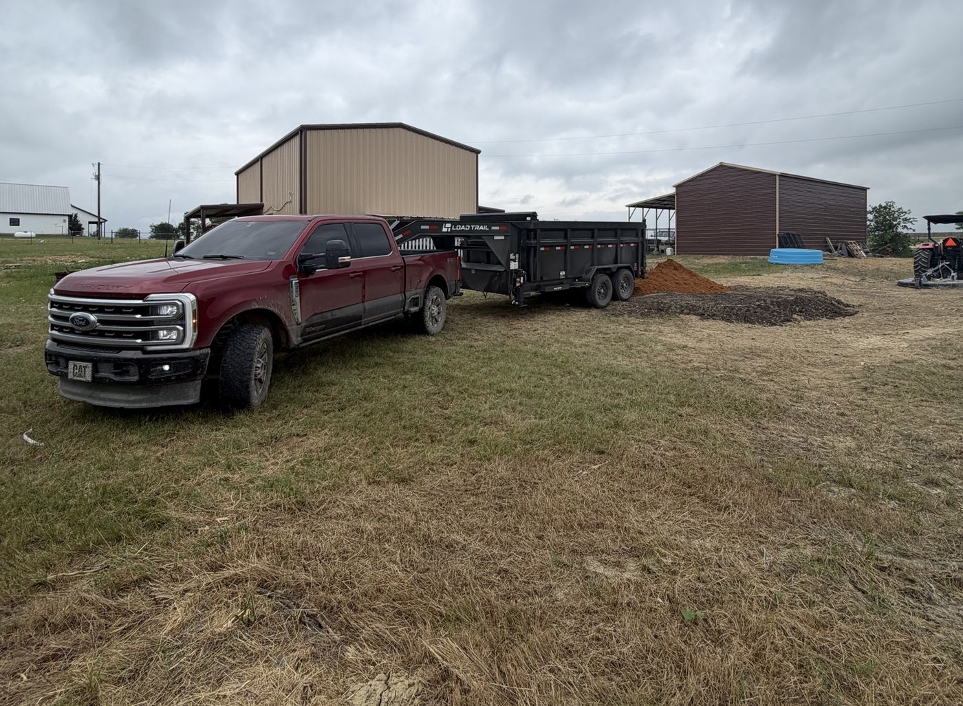 Dump trailer unloading dirt