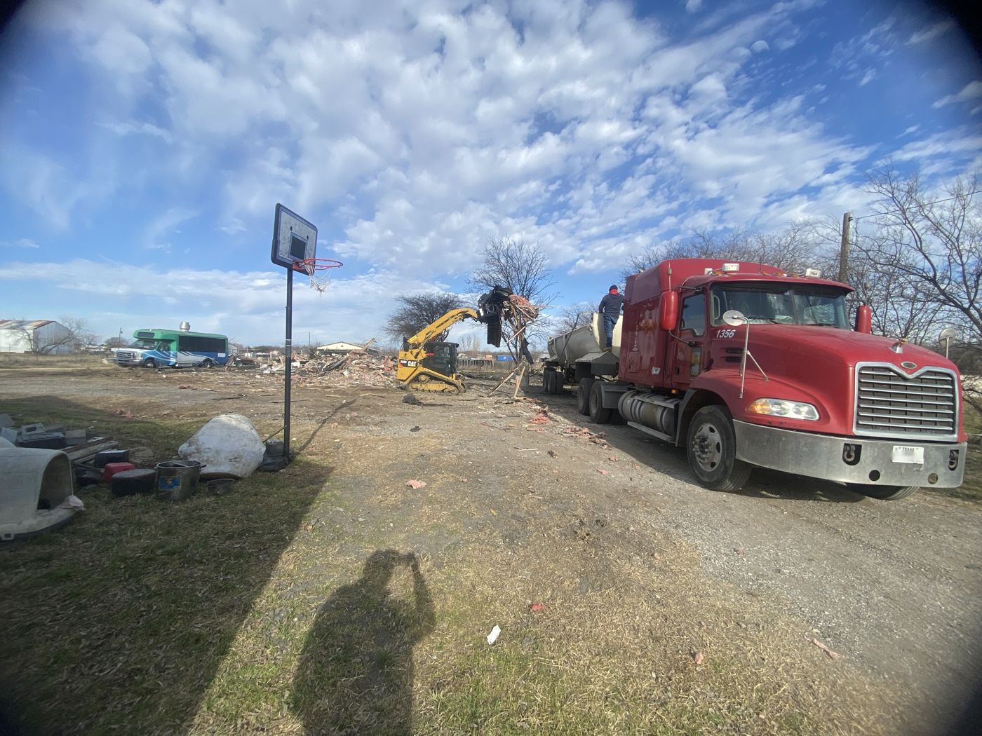 Skid steer loading demolition debris into an end dump