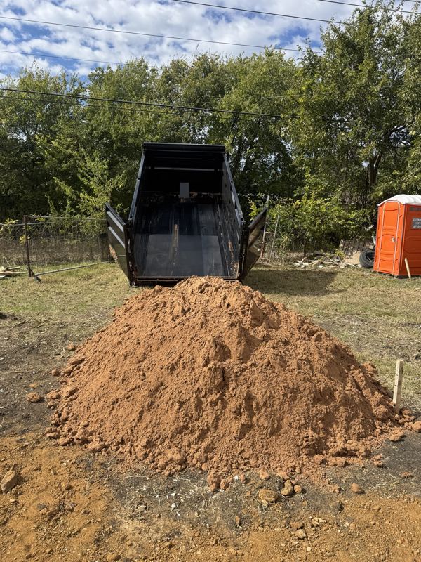 Sand dumped from a gooseneck dump trailer